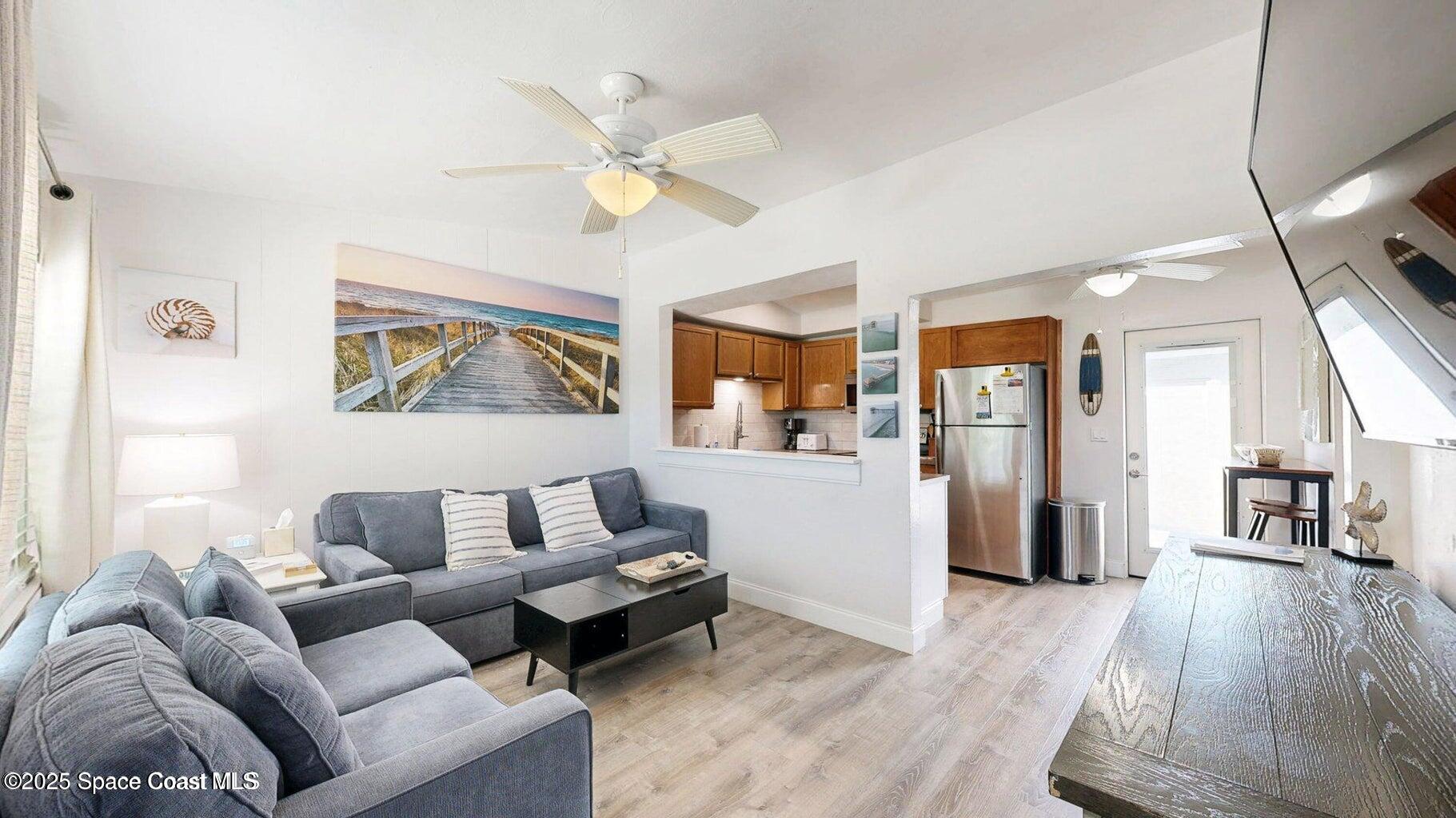 701 South Orlando Avenue, Unit A Cocoa Beach, FL 32931 - Photo 4 of 13 a living room with furniture and wooden floor