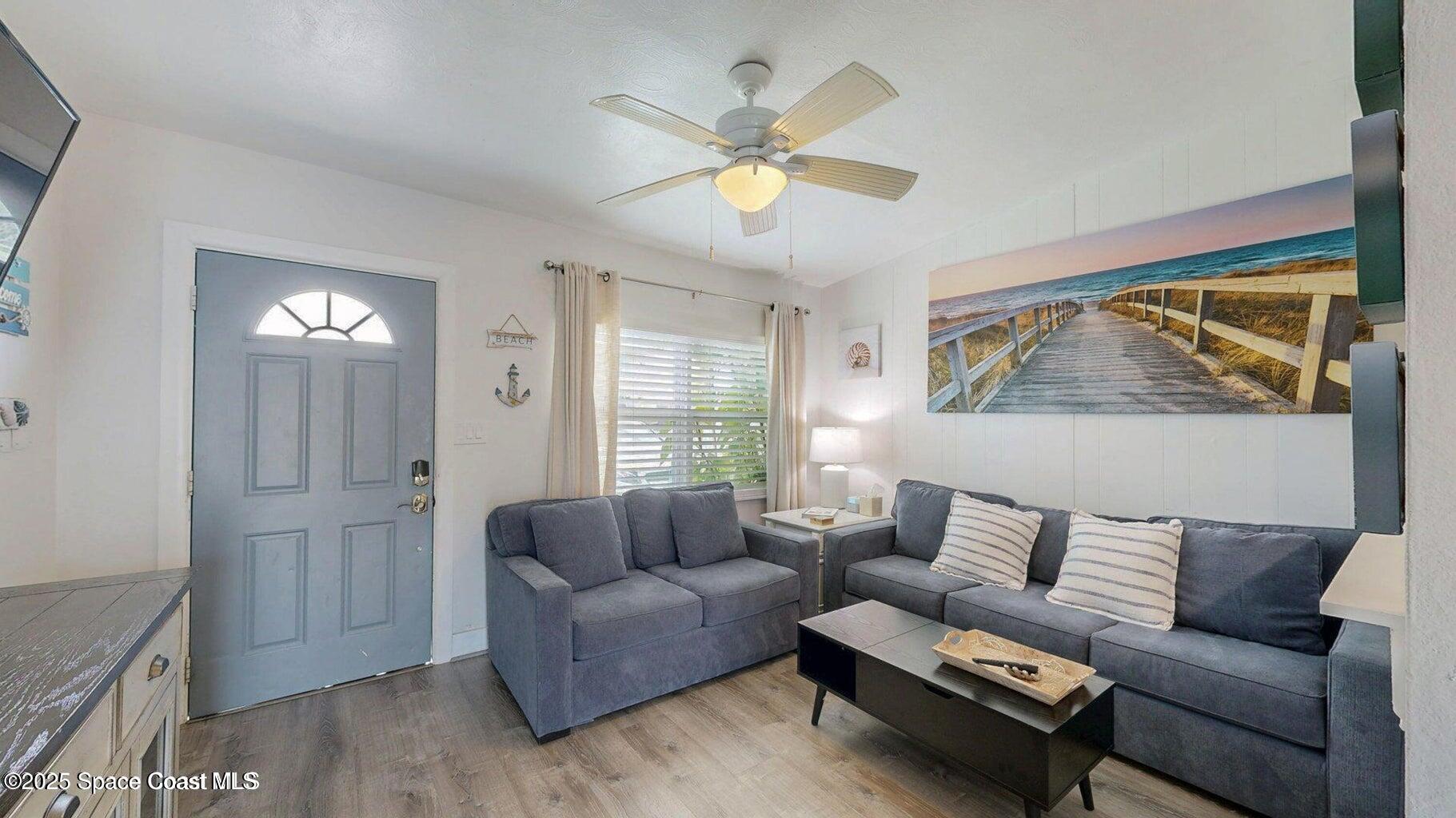 701 South Orlando Avenue, Unit A Cocoa Beach, FL 32931 - Photo 5 of 13 a living room with furniture and a window