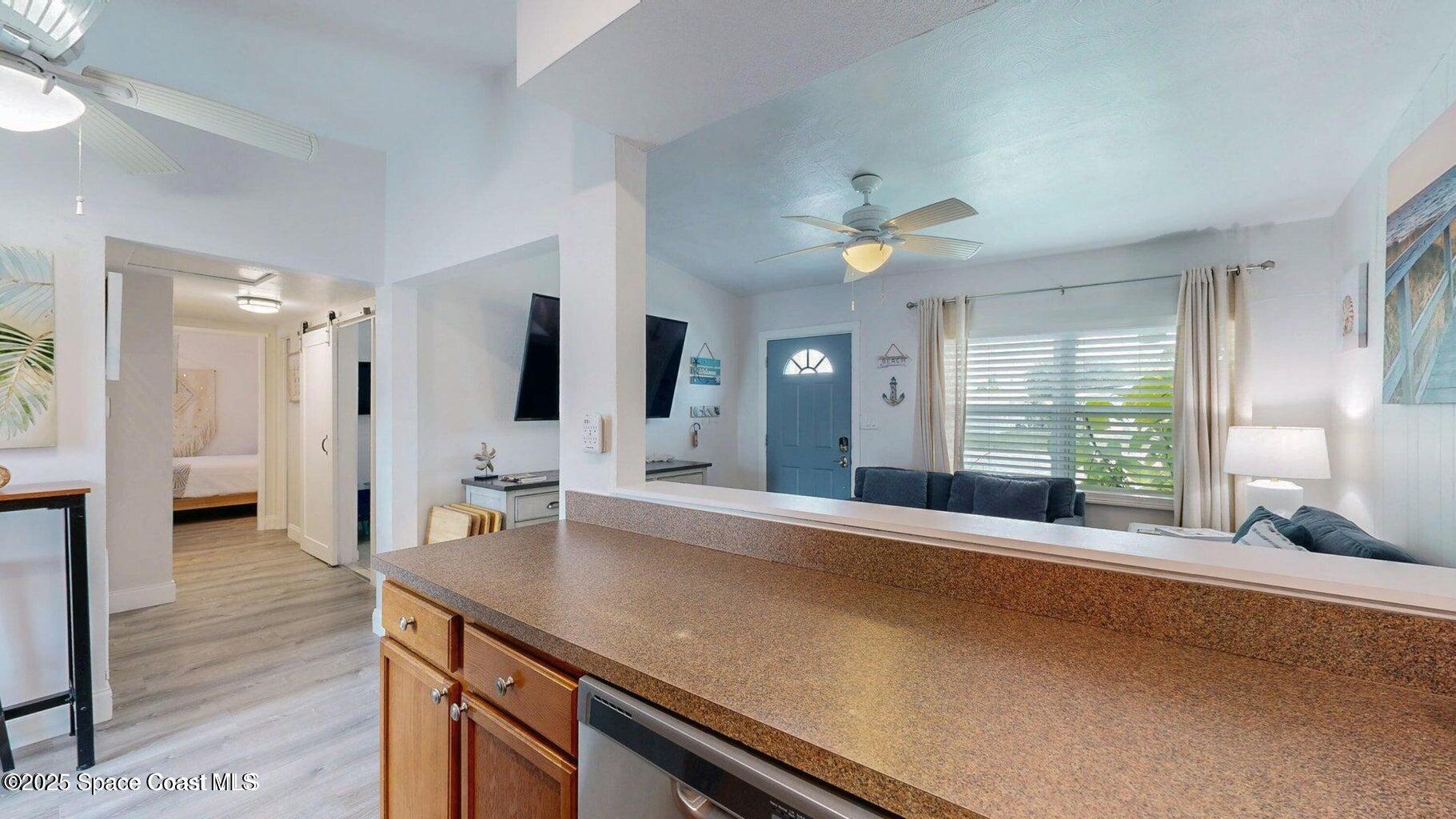 701 South Orlando Avenue, Unit A Cocoa Beach, FL 32931 - Photo 6 of 13 a spacious bedroom with a large bed and a chandelier