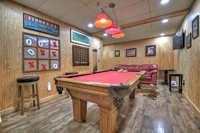 a room with stainless steel appliances kitchen island granite countertop a dining table and chairs with wooden floor