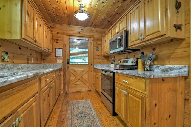a kitchen with stainless steel appliances granite countertop a sink and cabinets