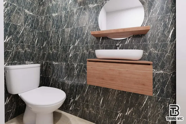 a bathroom with a toilet and a mirror