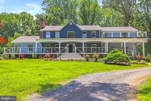 a front view of a house with a yard table and chairs