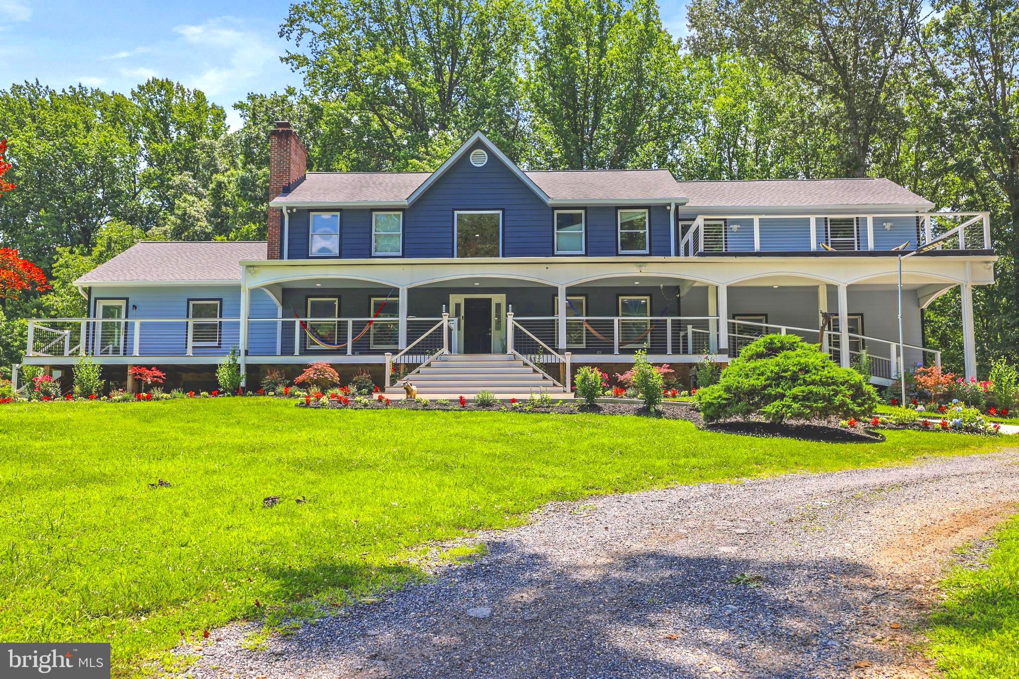 a front view of a house with a yard table and chairs