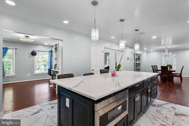 a kitchen with stainless steel appliances granite countertop a sink a stove and cabinets
