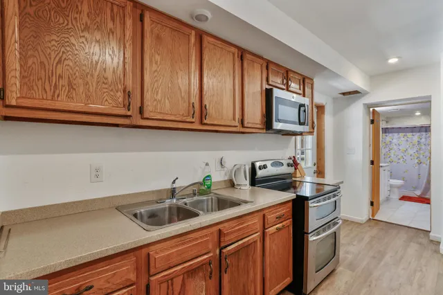 a kitchen with stainless steel appliances granite countertop a sink and a cabinets