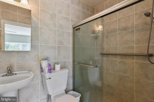 a bathroom with a sink a mirror and a shower