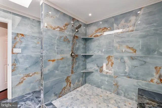 a bedroom with a bed and a wooden floor