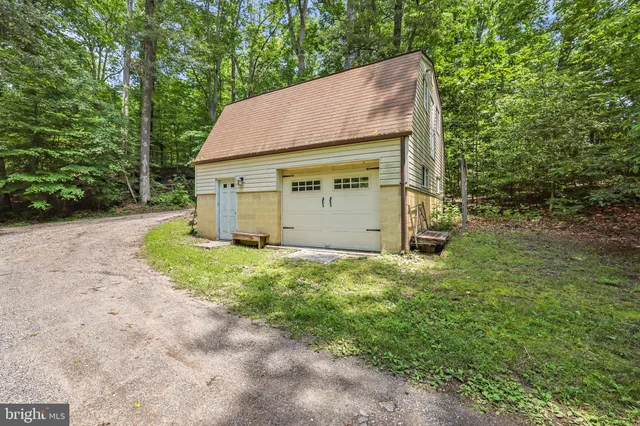 a view of a patio with table and chairs under an umbrella