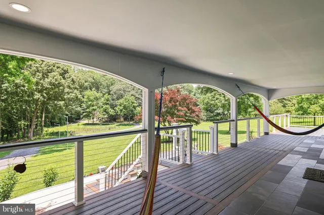 a view of a house with a yard and large tree