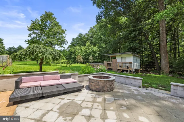 a aerial view of a house with a yard table and chairs