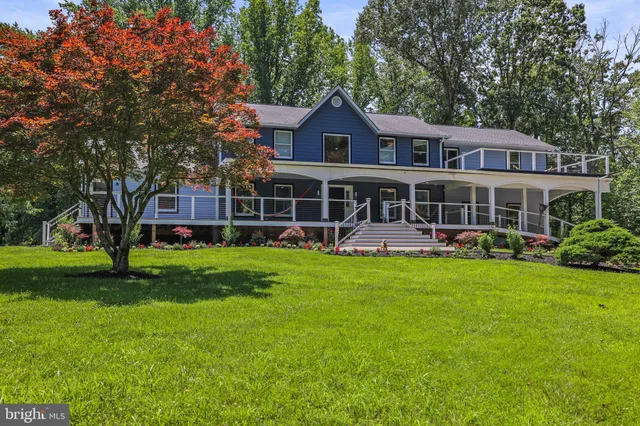 a view of a house with a yard and sitting area