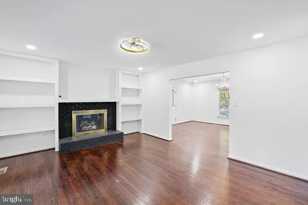 a view of a room with wooden floor and a window