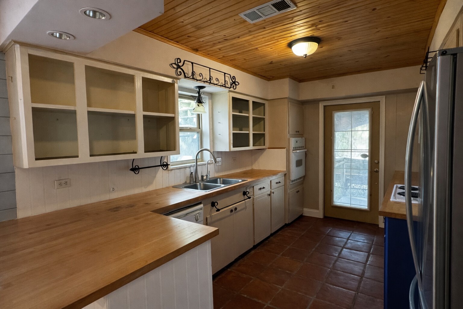 202 Hardy Street Bacliff, TX 77518 - Photo 7 of 21 a kitchen with a sink and a refrigerator