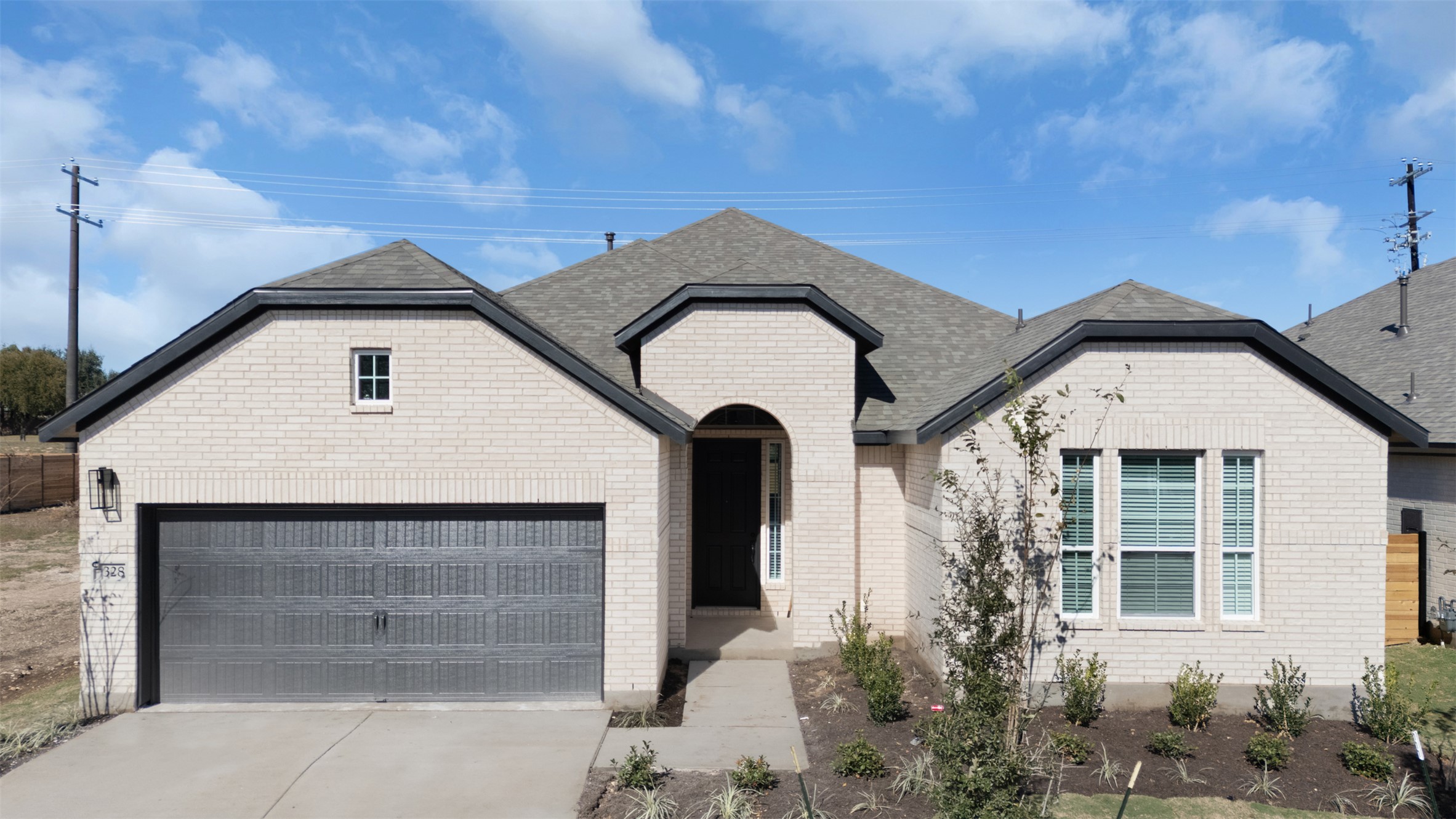 328 Ridgewell Loop Georgetown, TX 78633 - Photo 1 of 28 View of front of house with driveway, a garage, roof with shingles, and brick siding