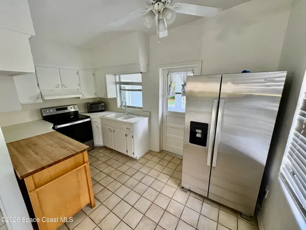 a kitchen with stainless steel appliances a refrigerator sink and microwave