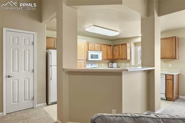 a view of a kitchen from the hallway