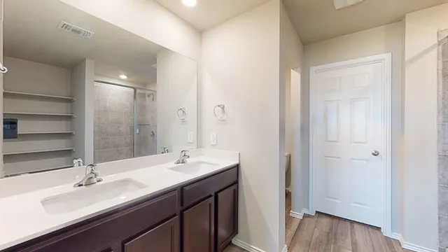 a bathroom with a double vanity sink and a mirror