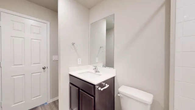 a bathroom with a sink toilet and vanity