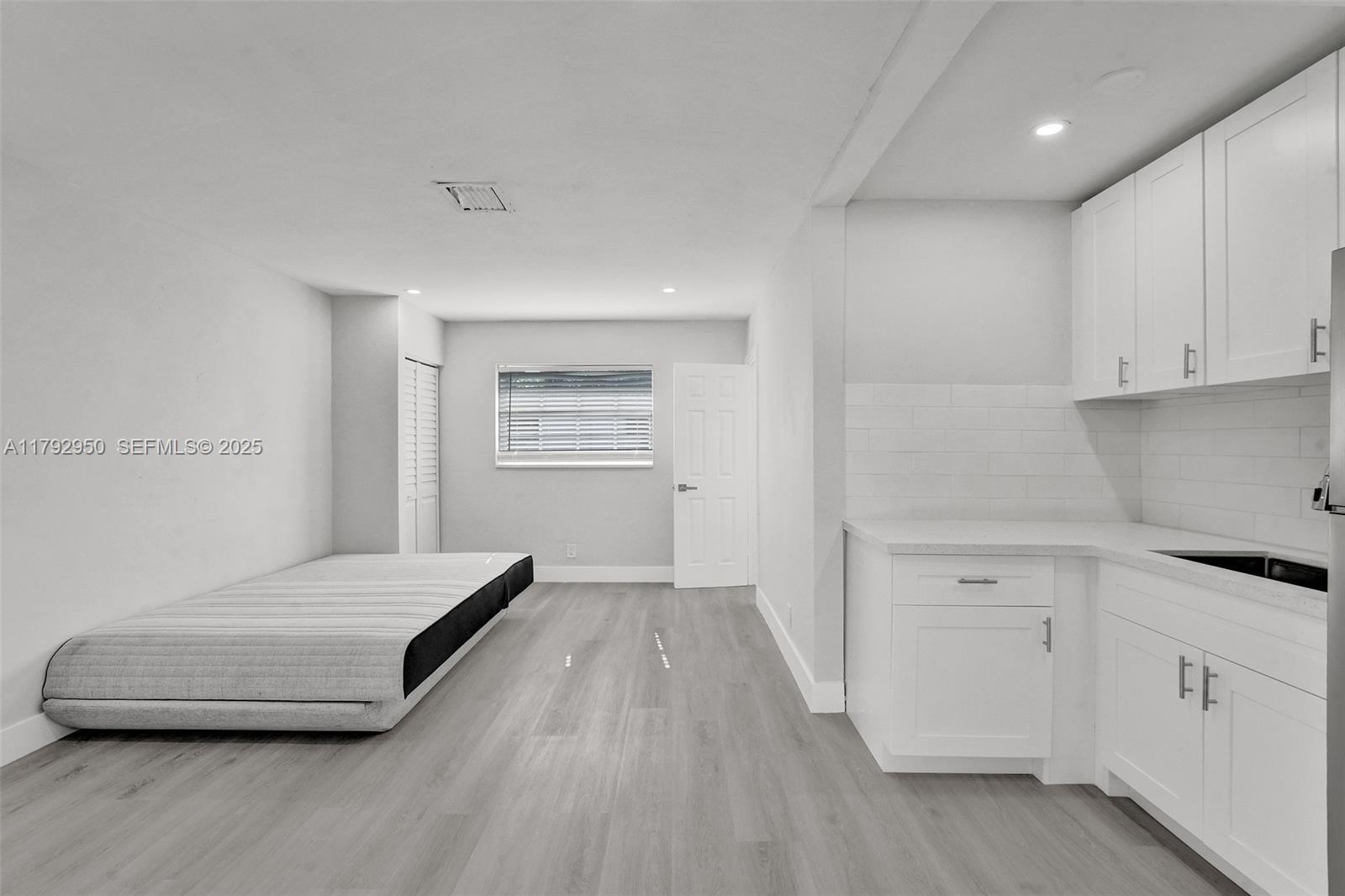 5657 Grant Street Hollywood, FL 33021 - Photo 22 of 59 a room with a bed and a view of kitchen