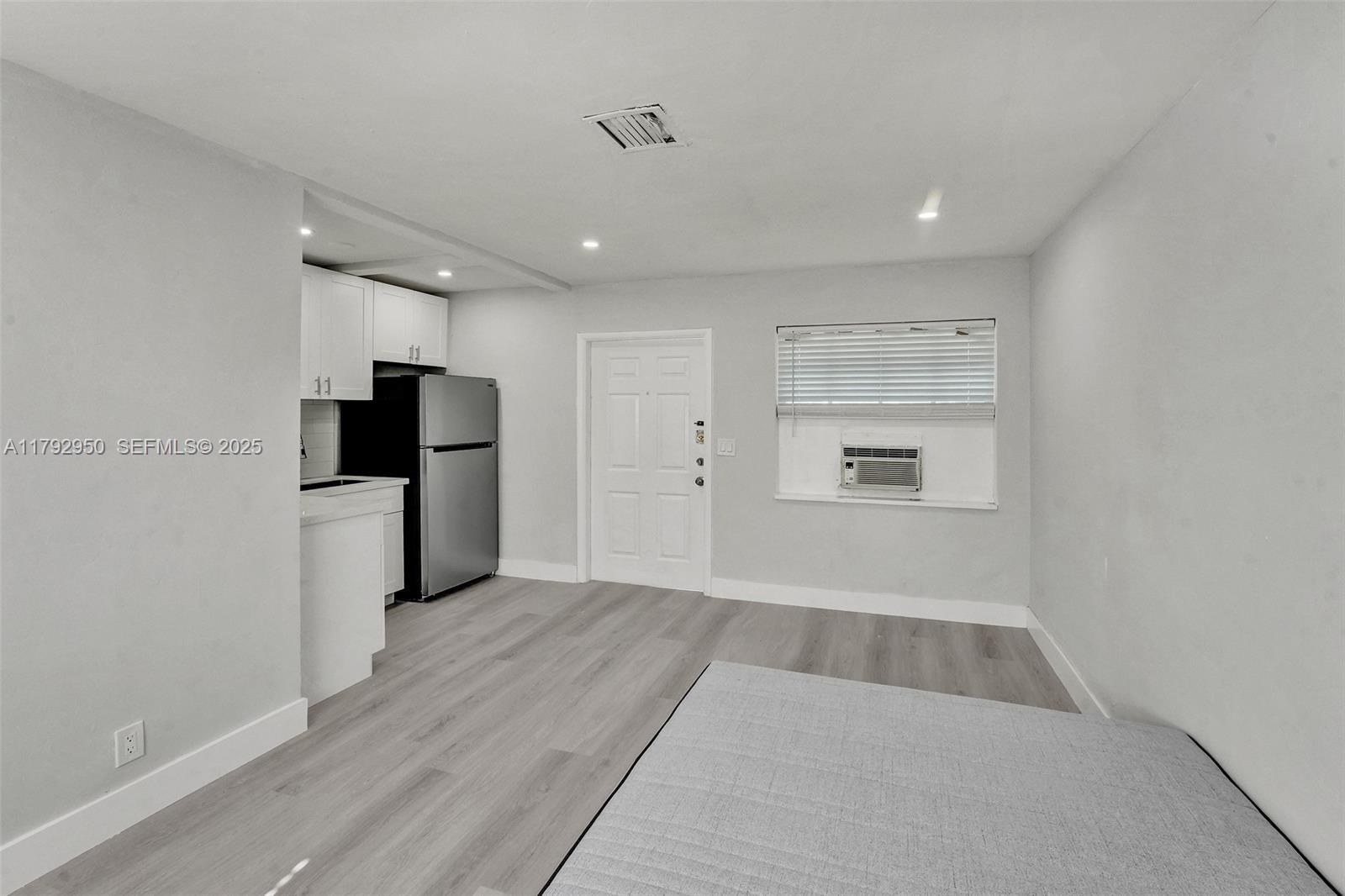 5657 Grant Street Hollywood, FL 33021 - Photo 27 of 59 a view of a kitchen with a refrigerator a stove top oven and cabinets