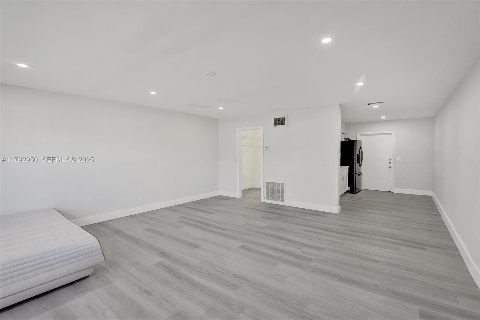 5657 Grant Street Hollywood, FL 33021 - Photo 31 of 59 a view of an empty room with wooden floor and a closet