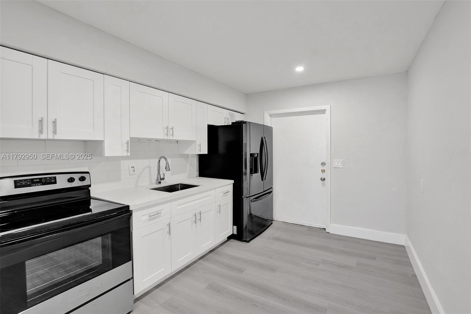 5657 Grant Street Hollywood, FL 33021 - Photo 32 of 59 a kitchen with stainless steel appliances a stove and a refrigerator