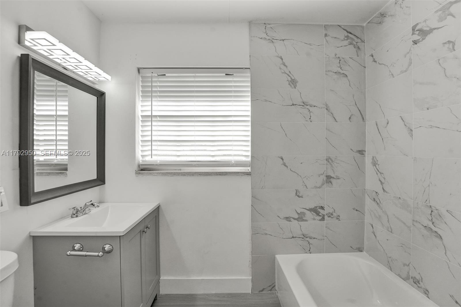 5657 Grant Street Hollywood, FL 33021 - Photo 40 of 59 a bathroom with a sink a toilet and a bathtub