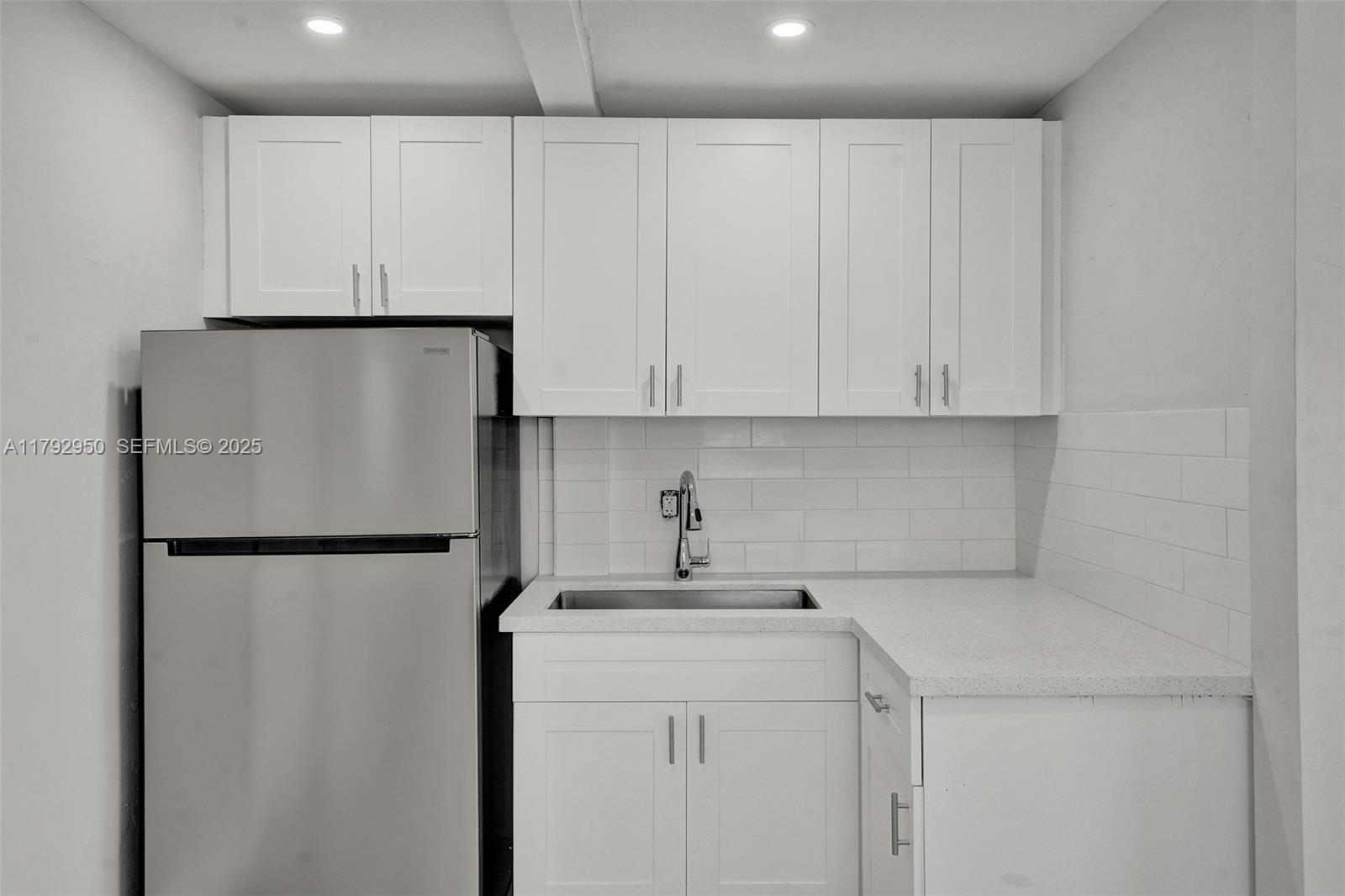 5657 Grant Street Hollywood, FL 33021 - Photo 45 of 59 a white refrigerator freezer sitting in a kitchen