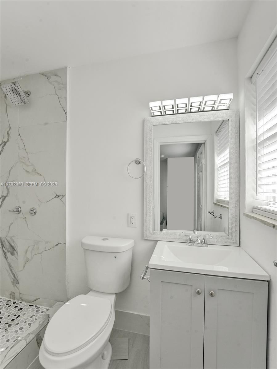 5657 Grant Street Hollywood, FL 33021 - Photo 48 of 59 a bathroom with a sink a toilet and shower