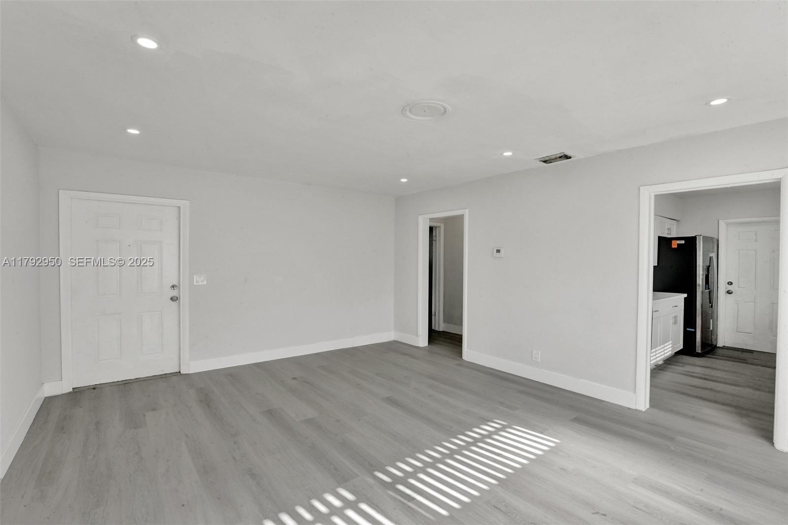 5657 Grant Street Hollywood, FL 33021 - Photo 5 of 59 a view of an empty room with wooden floor