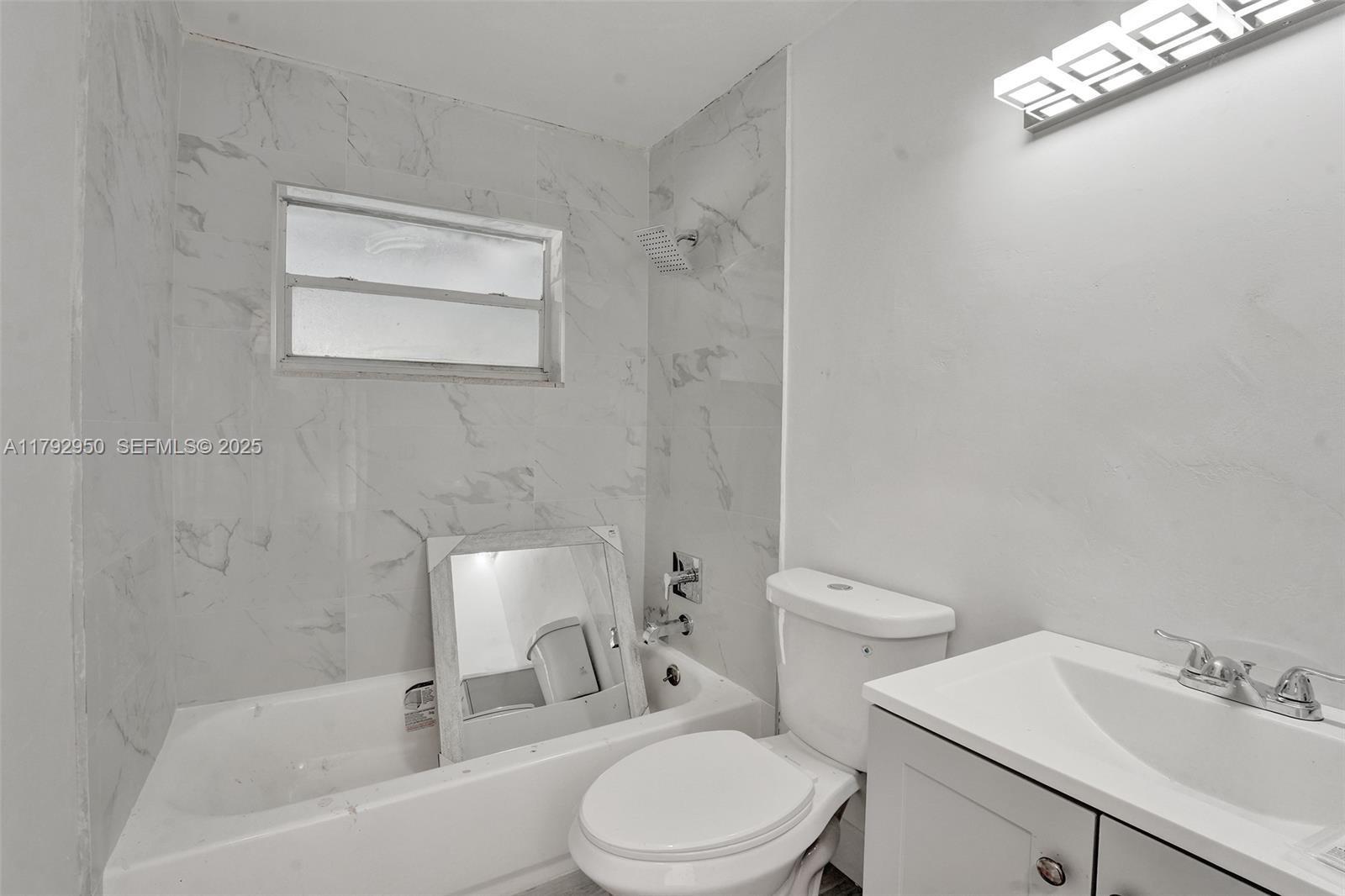 5657 Grant Street Hollywood, FL 33021 - Photo 10 of 59 a bathroom with a sink toilet and shower