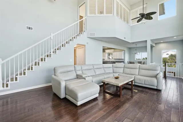 a spacious bedroom with a bed and a chandelier