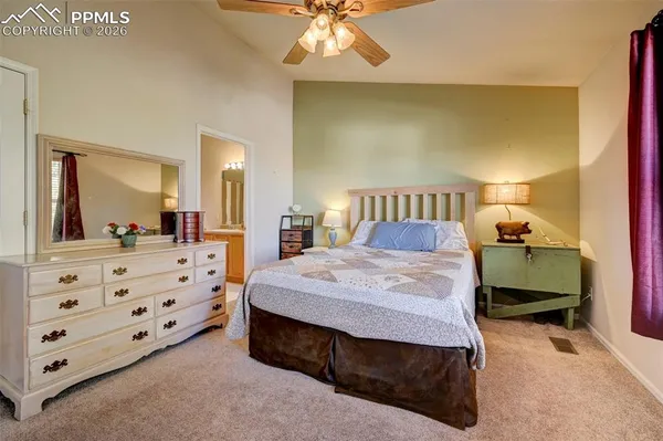 a bedroom with a bed a dresser and a mirror