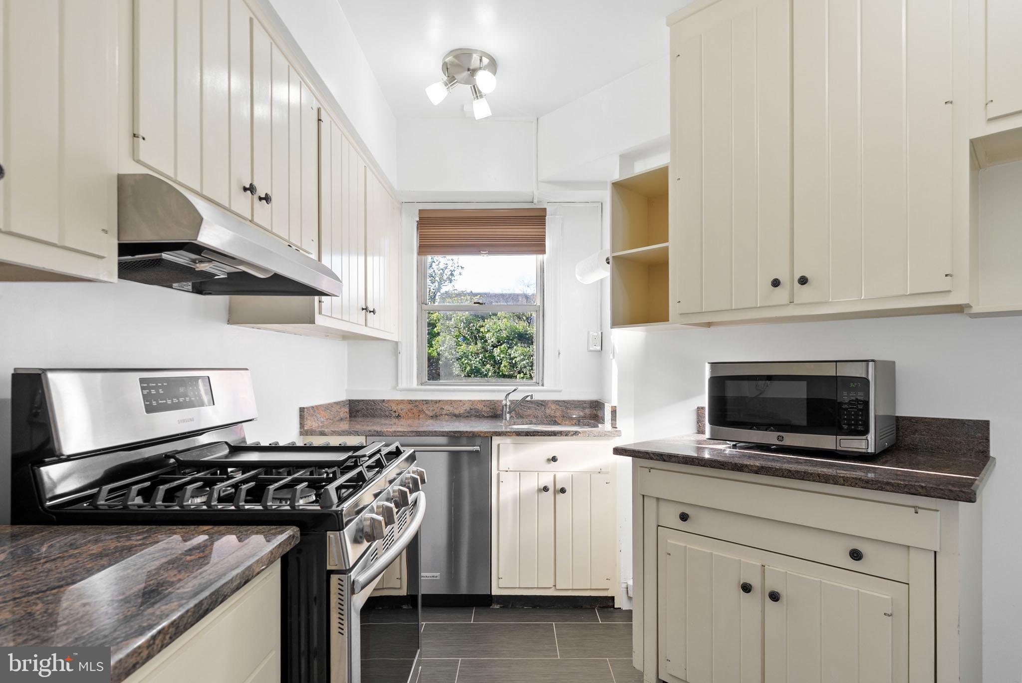 2500 Q Street Northwest, Unit 214 Washington, DC 20007 - Photo 4 of 18 Bright kitchen with stainless-steel appliances