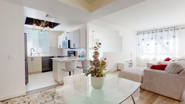 a kitchen with white cabinets and white appliances