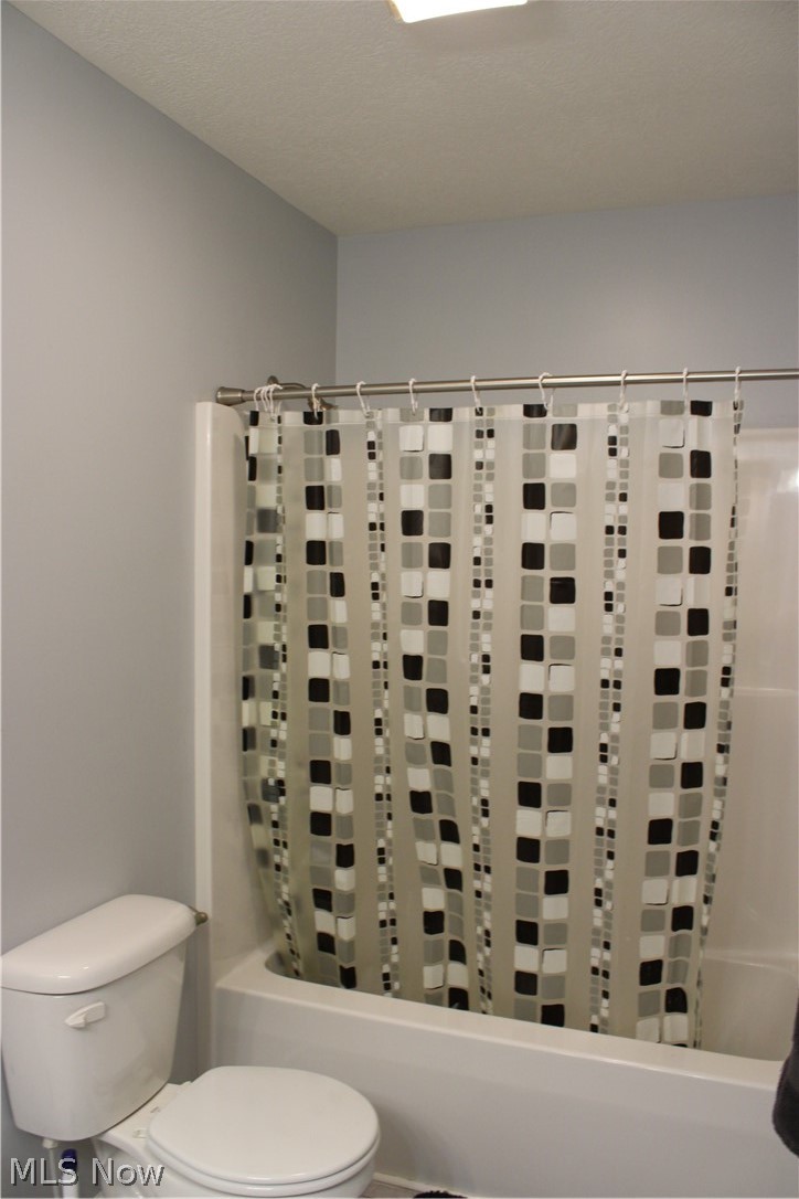 202 Home Street Rittman, OH 44270 - Photo 37 of 47 White bathtub with a chrome shower rod and light gray wall paint