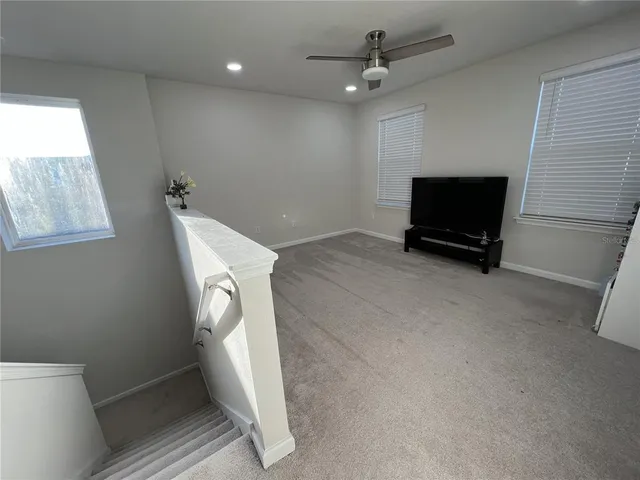 a view of a porch with chairs and potted plant