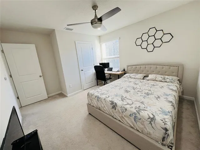 a bedroom with a bed and chair