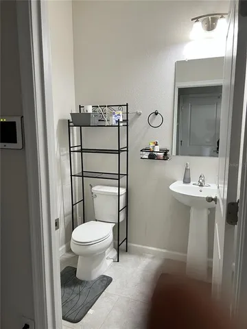 a spacious bedroom with a bed a couch and a large window