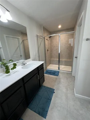 a bathroom with a shower and a bath tub