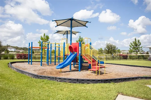 a swimming pool with outdoor seating and barbeque oven