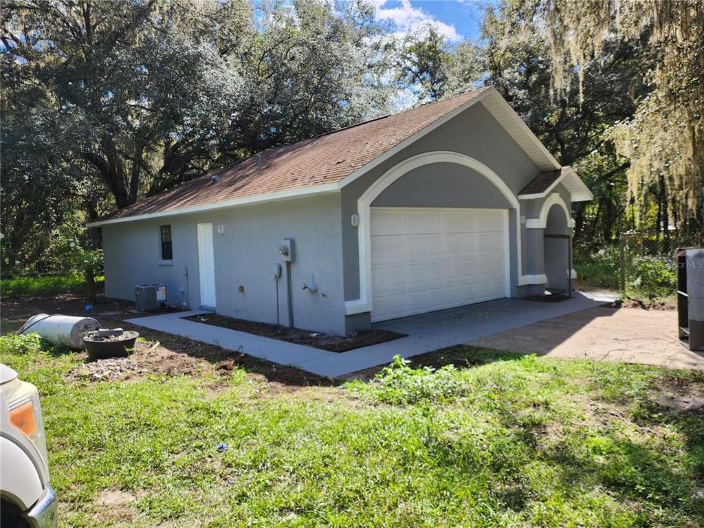 13767 Northeast 47th Avenue Anthony, FL 32617 - Photo 1 of 7 a front view of house with backyard and trees