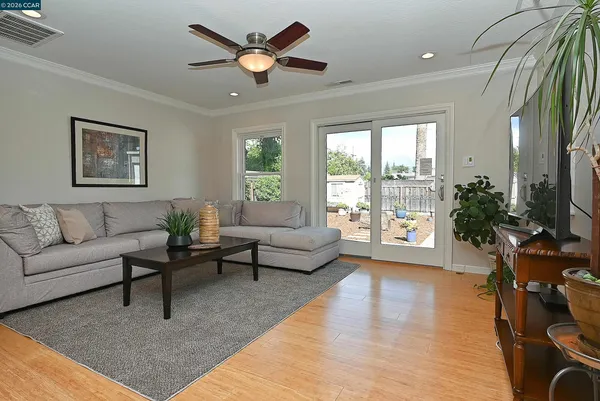a living room with furniture a large window and a rug