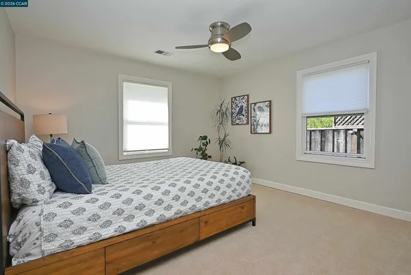 a bedroom with a large bed and a window