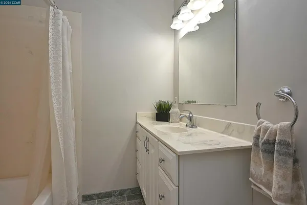 a bathroom with a sink vanity and a mirror