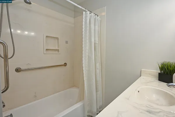 a bathroom with a tub and shower