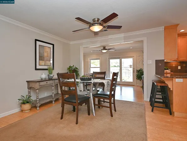 a view of a dining room with furniture and a chandelier
