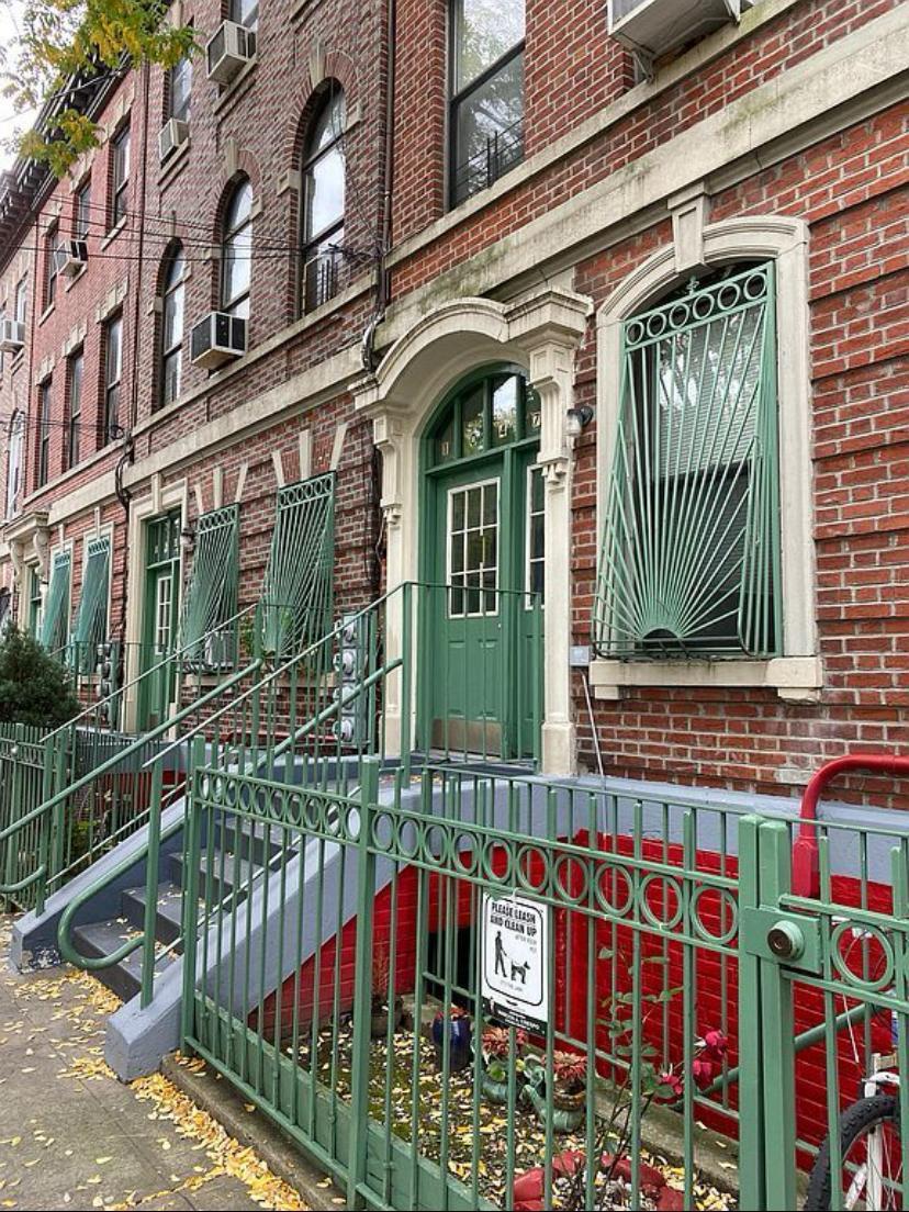 a view of front door of house with large windows