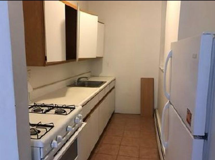 1047 Faile Street, Unit 1047A Bronx, NY 10459 - Photo 5 of 10 a kitchen with stainless steel appliances a refrigerator and a stove